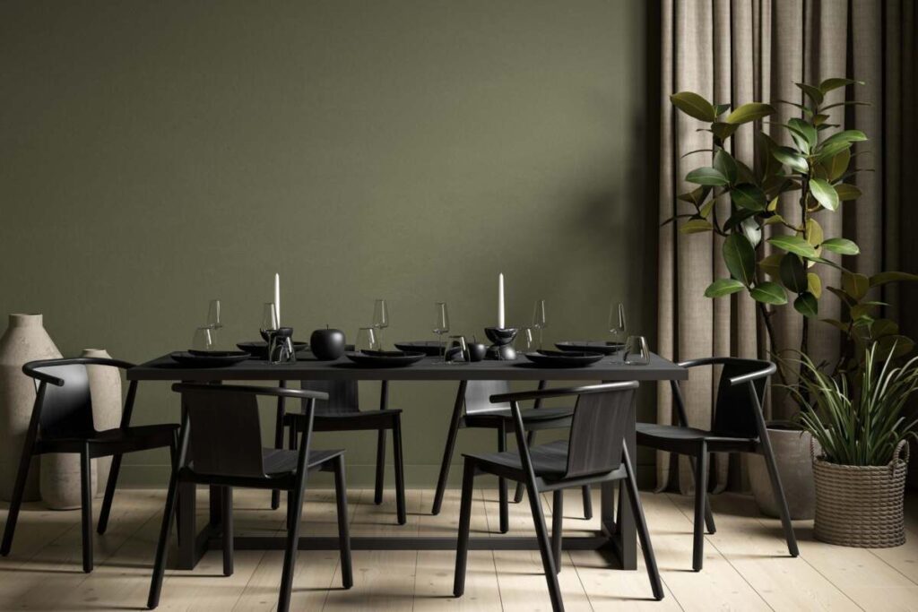 Green wall with black dinning table and chairs for goth decor