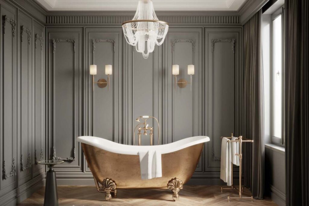 Brass finished bathroom tub with crown molding walls and a crystal chandelier for gothic home decor