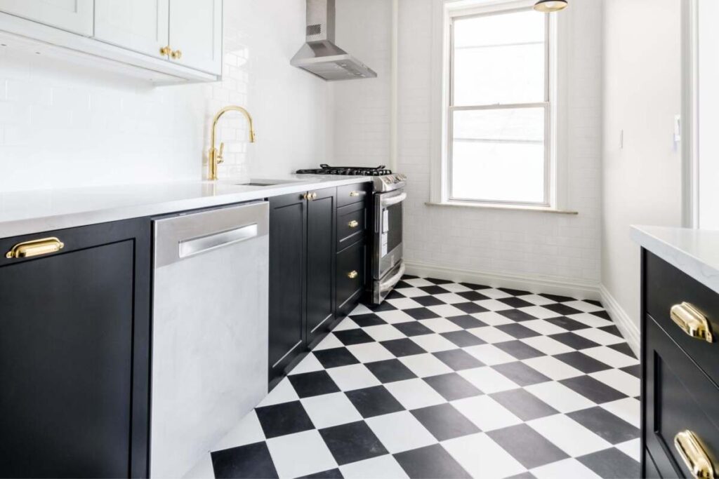 Kitchen floor with black and white checkerd vinyl floors.
