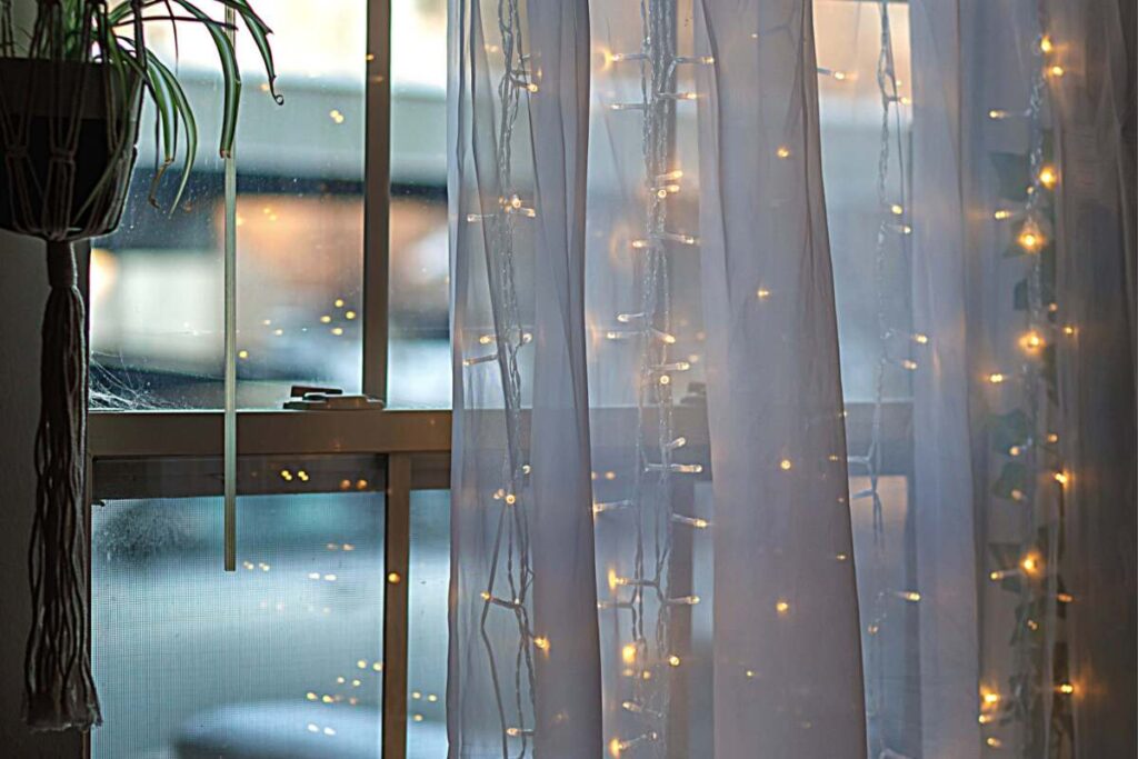 Fairy lights on white sheer curtains