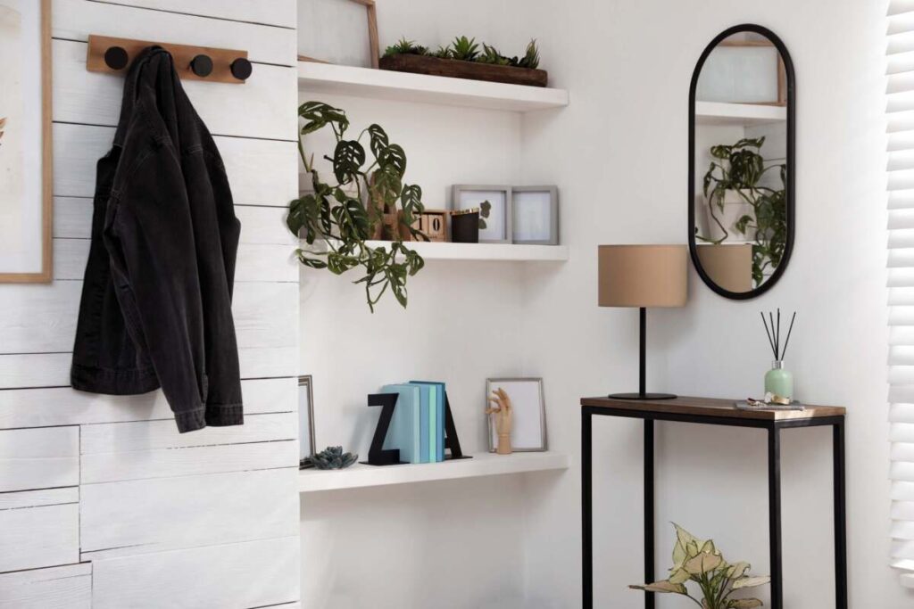 entryway with shelves, table and a mirror