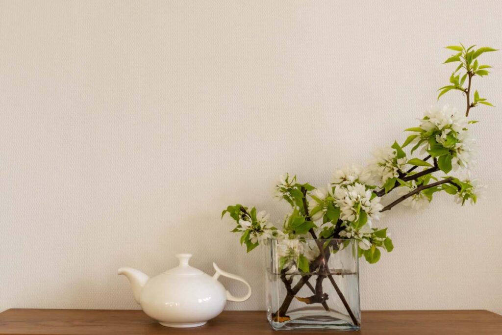 table with a plant and a teapot for entryway 