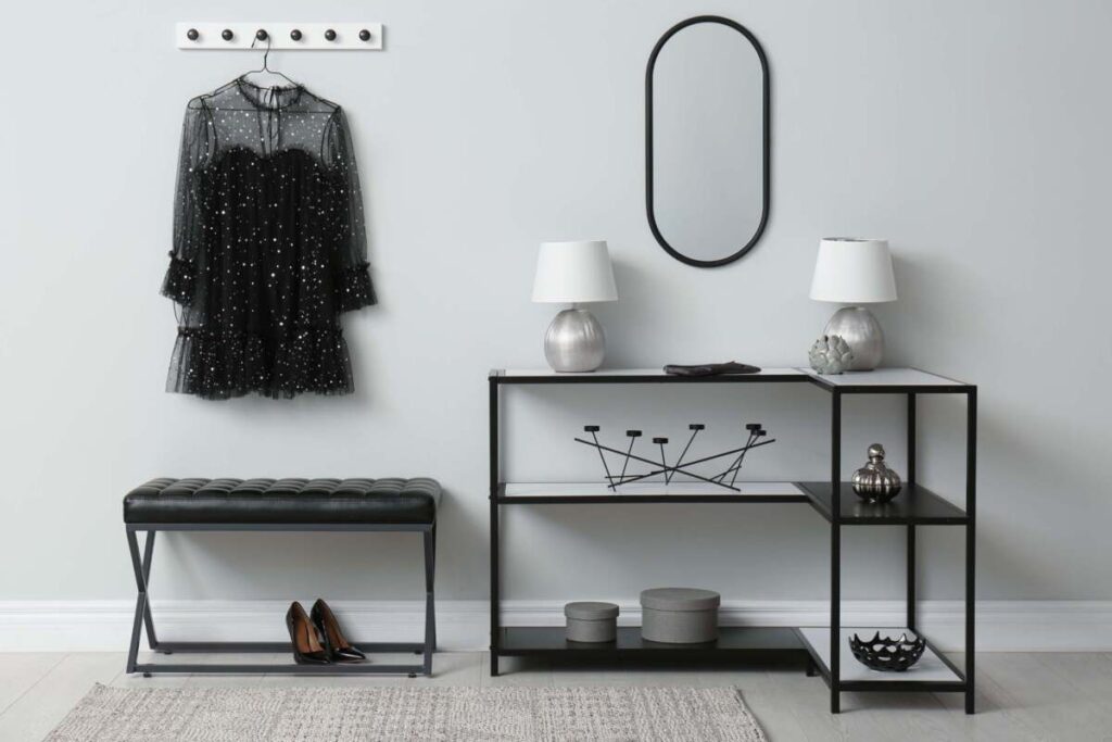 chic black entryway with two small white and silver table lamps