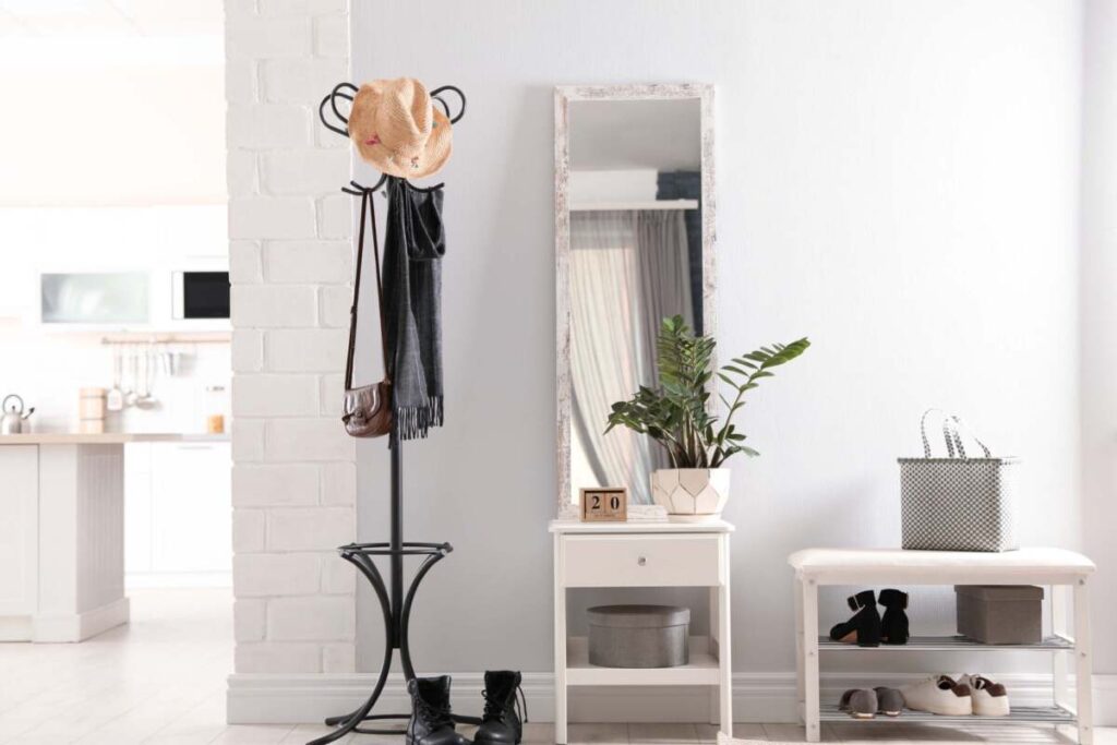 entryway with coat rack and white table