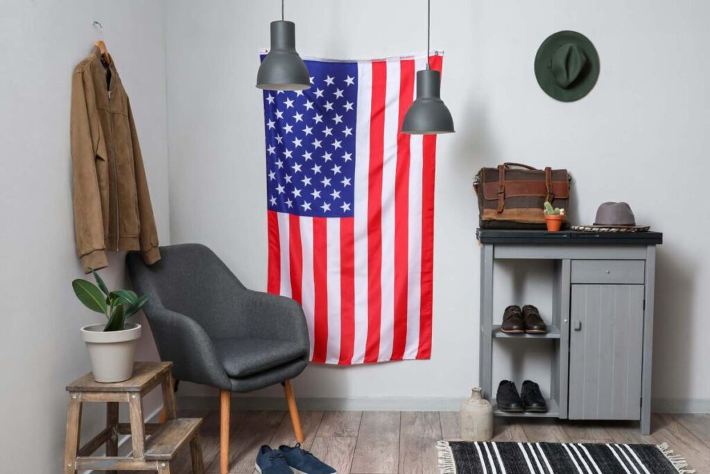 Entryway with black chair, shoe rack, pendant lights and American flag