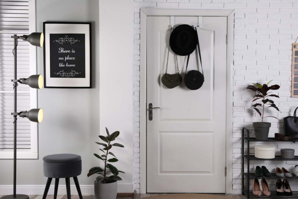 entryway with black stool and plant