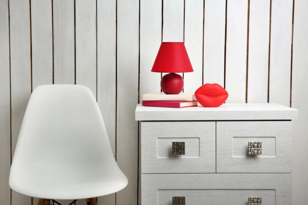 entryway table with a small red table lamp