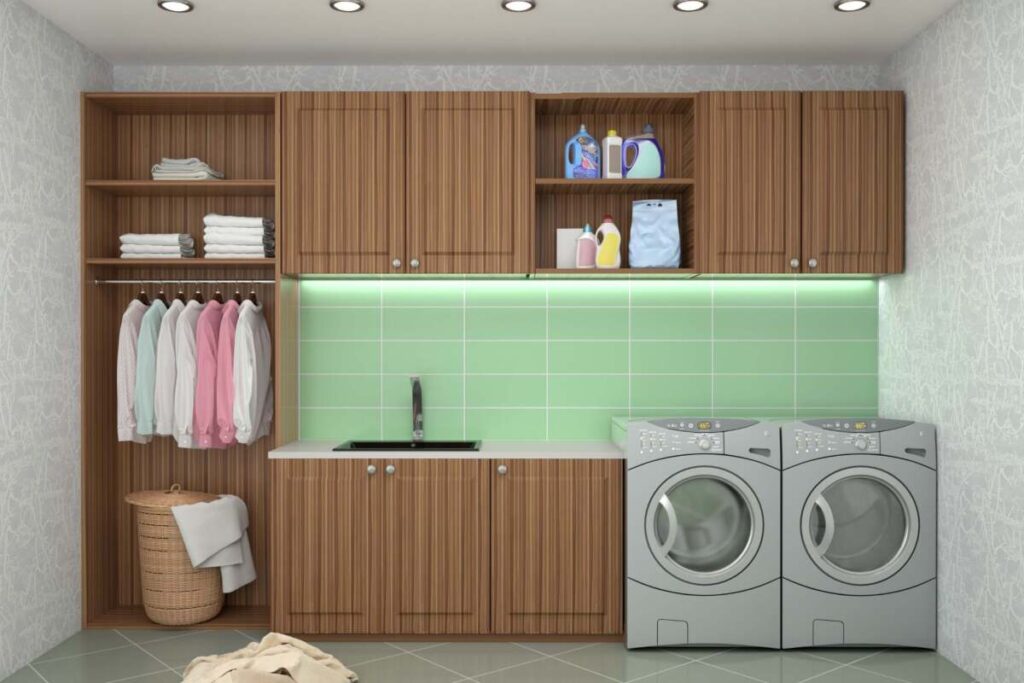 laundry room with a green backsplash and lights