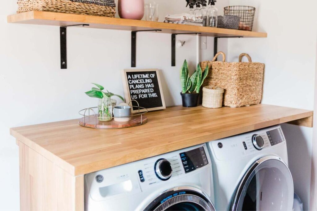 Small laundry room with wood table