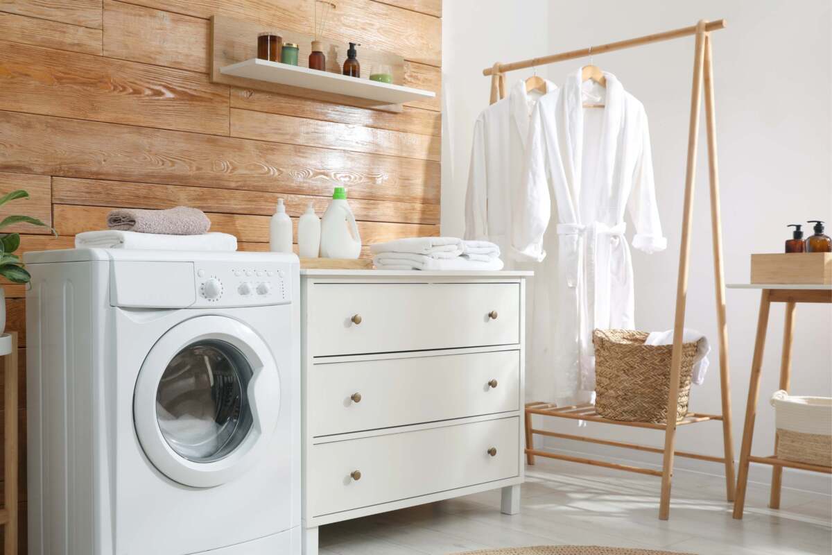 Small laundry room with wood walls